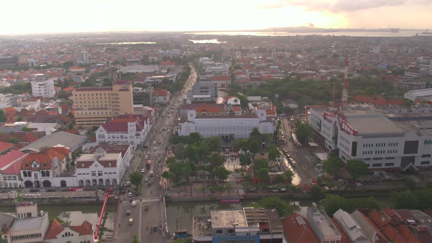 aerial view of Kota Lama Surabaya (Surabaya Old Town), specifically the European Zone near the iconic Jembatan Merah (Red Bridge) in East Java, Indonesia. The prominent white building in the center is part of the historic colonial-era architecture that defines this revitalized district
