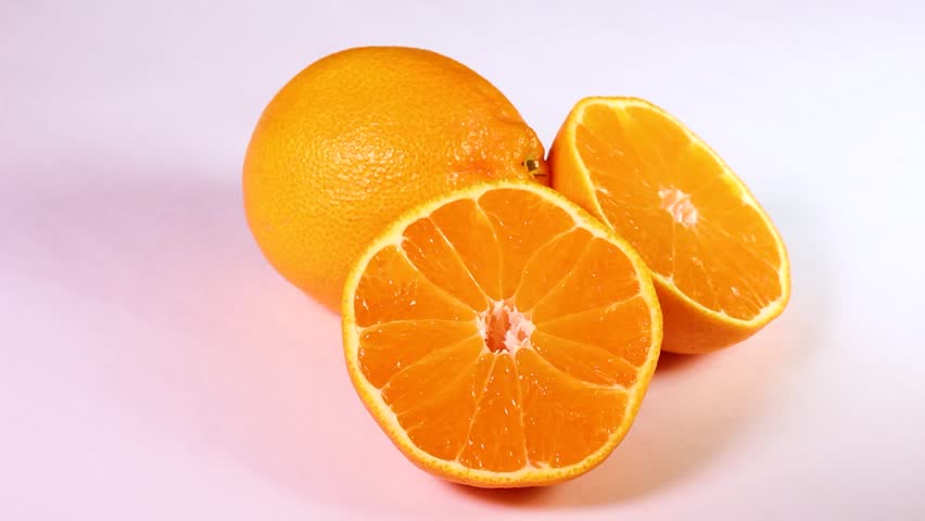 A set of a single whole rotating Dekopon (Shiranui citrus) and its juicy cross section on a white background