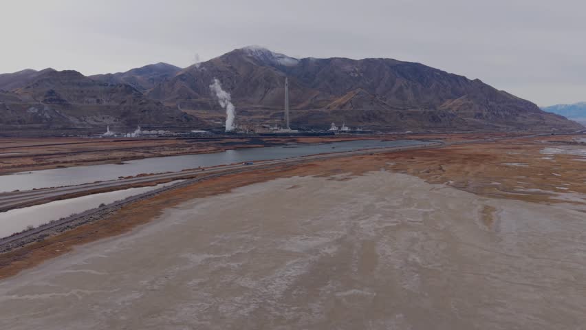 Aerial view of industrial smelter stack near Great Salt Lake in Magna, Utah