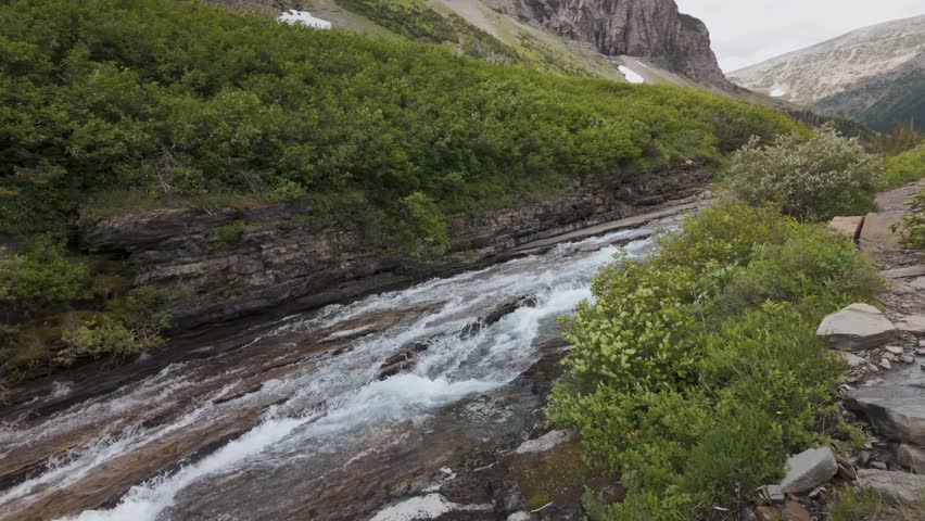 Cascading mountain stream flowing over rocky ledges in Montana