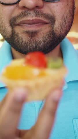 Enjoying a colorful fruit tart at a local dessert shop