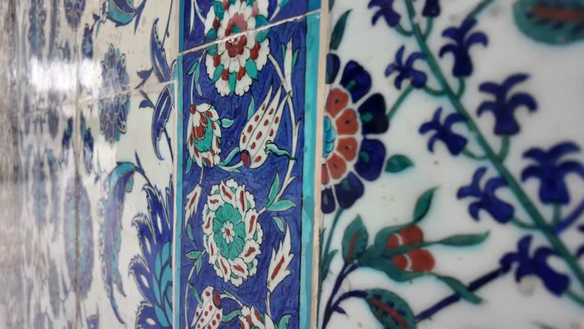 Colorful tile art displays intricate designs in a historical setting