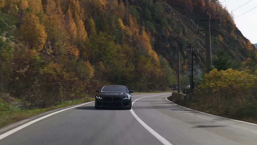 Black luxury spots car driving on a scenic winding road through an autumn forest, traveling on vacation