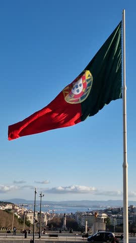Giant Flag of Portugal fluttering in the wind in Lisbon
