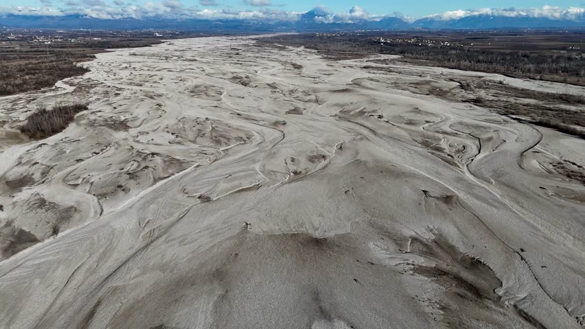 Aerial footage flying over a vast, dry riverbed showing the effects of a severe drought