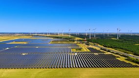 Yellow agricultural fields with solar panels. Wind farms located nearby. Aerial perspective. - Powered by Shutterstock - Get 15% off with code: PIKWIZARD15