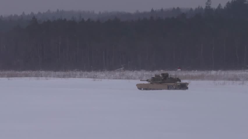 Several Allied armored vehicles and other combat vehicles conduct live fire on the snowy battlefield.