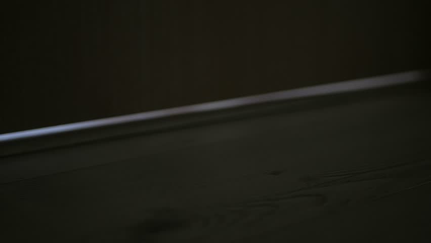 Person Letting a Letter in Front of the Entrance Door for Postman. Man Leaving an Envelope in Front of the Door.