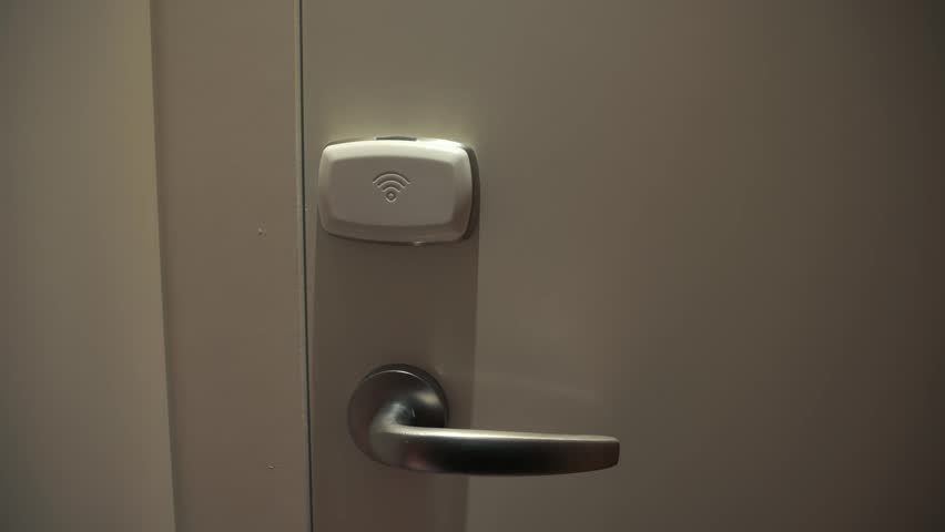 A close-up of a key card being used to open a hotel room door. High quality 4k footage