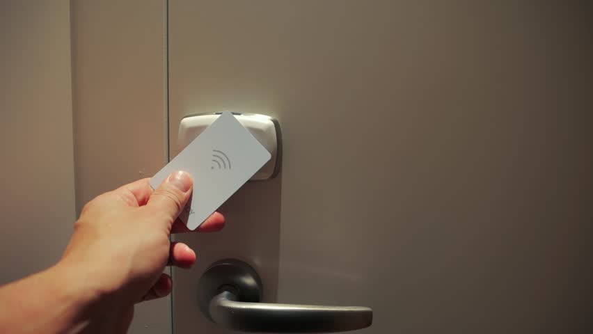 A close-up of a key card being used to open a hotel room door. High quality 4k footage