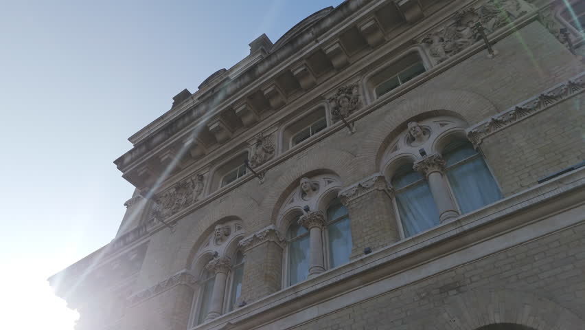Close-up architectural footage showcasing historic gargoyle figures and ornate stone detailing on the façade of The Langham Hotel in Marylebone, Central London. 

The shot highlights fine craftsmanship, heritage design, and the distinctive character of one of London’s most iconic luxury hospitality landmarks. 

This visually rich architectural detail is ideal for history, heritage, travel, culture, design, and editorial storytelling projects set in London, United Kingdom.
