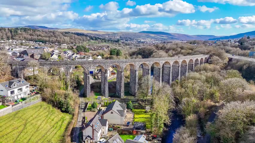 A receding aerial view flying away from the Cefn Coed Viaduct at Merthyr Tydfil, Wales, UK