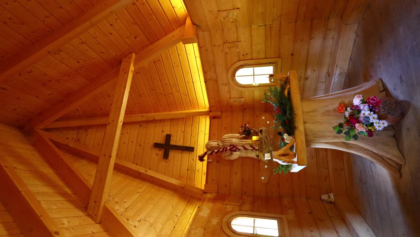 Interior of a small wooden chapel with fully timbered walls, warm lighting and a simple altar, capturing peaceful spiritual atmosphere, rustic craftsmanship and quiet rural devotion