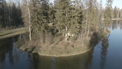 Aerial Rise over Pond Wooded Peninsula