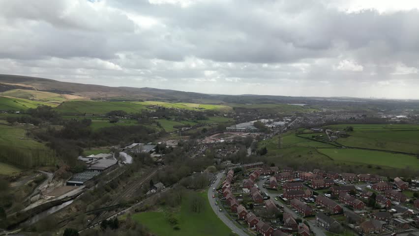 View of a town and hills under cloudy sky from a high point