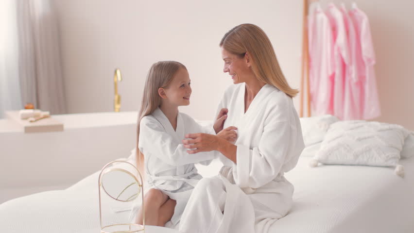 Mother and Daughter Sharing a Joyful Moment in a Bright Spa Room