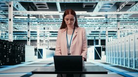 Woman at server hub workplace desk monitors rigs power consumption with laptop. Data center employee oversees equipment with notebook, ensuring industry standards compliance, camera A - Powered by Shutterstock - Get 15% off with code: PIKWIZARD15