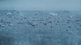 Cinematic close up rain falling on ground with strong splashes moody background - Powered by Shutterstock - Get 15% off with code: PIKWIZARD15