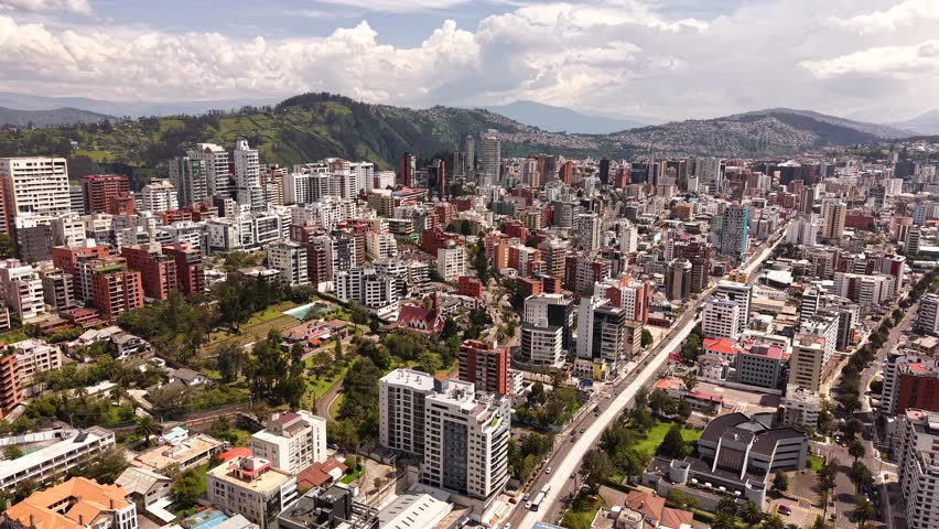 Stunning cinematic aerial drone footage of Quito, the capital city of Ecuador, captured from above with breathtaking views of the historic cityscape, urban skyline, and surrounding Andes Mountains
