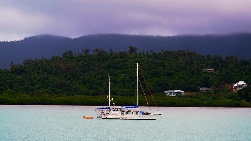 Sailboat Port of Airlie beach Coral Sea Marina boat ride cruise Great Barrier Reef Whitsunday islands Australia Queensland Hamilton Island Heart of the Reef coastline cloudy afternoon sunset pan