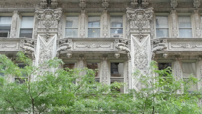 New York City Manhattan Midtown historic building 1909, facade architecture, United States of America. Real estate property on 7 seventh avenue. Classic style design landmark. Windows and greenery.