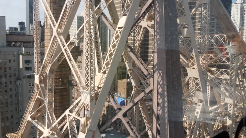 New York City Queensboro bridge architecture from Queens to Manhattan Midtown, United States. Urban public transport, tramway to Roosevelt island over East River. Metallic bridge road to East Side.