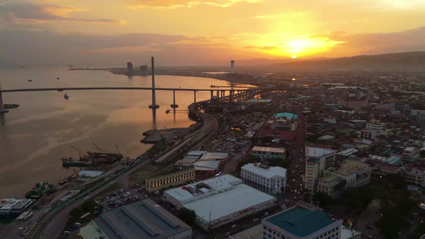 Sunset drone aerial skyline cityscape view of Cebu City Philippines island golden hours light