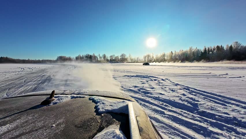 Rear wheels throwing sparkling powder, car mounted camera showcasing drifting skills on a frozen lake