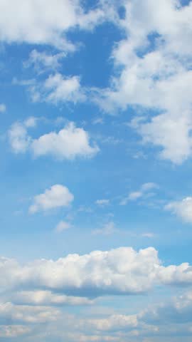 vast expanse of brilliant blue sky dotted with fluffy, white clouds.Several clouds of varying sizes are scattered across the blue backdrop. It evokes a feeling of open space and a peaceful atmosphere
