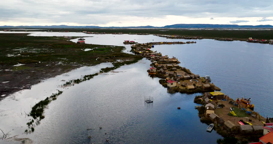 Indigenous Settlements Of Uros Floating Islands On Lake Titicaca In Peru, South America. Aerial Drone Shot