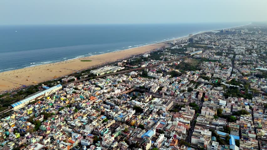 Aerial perspective of Chennai’s Triplicane area, highlighting the sacred temple tank, bustling urban blocks, and vibrant neighborhood landscape close to the Marina coastline.