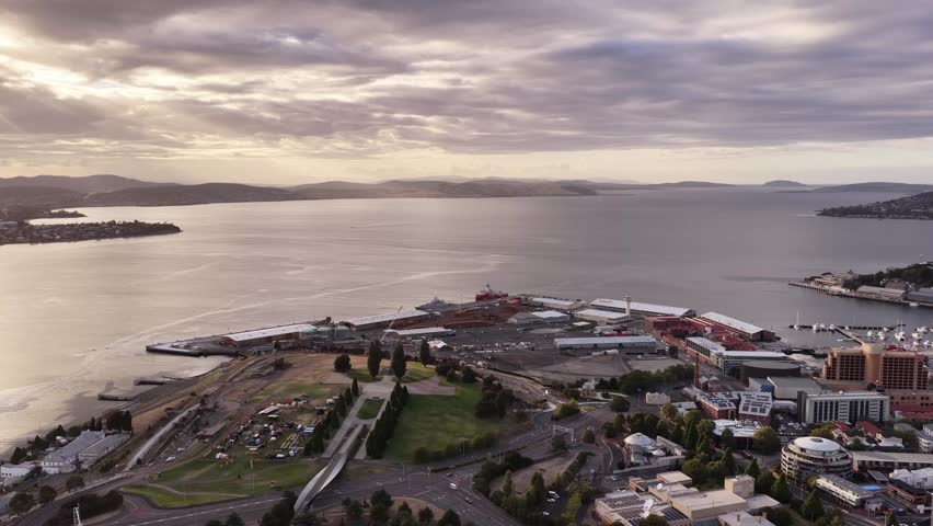 high aerial hovering panorama over Hobart city Tasman river harbour waterfront.