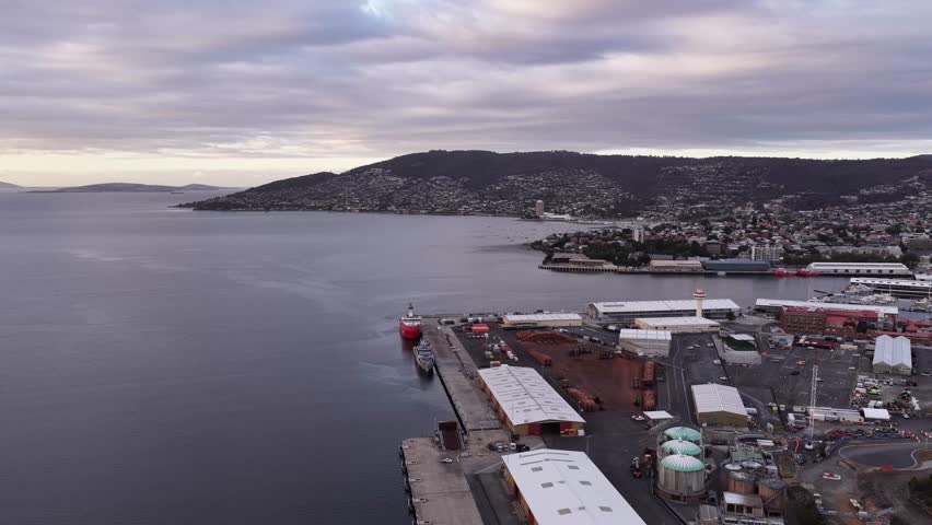 Hobart port to Tasman bridge across Derwent river aerial panorama at sunrise.