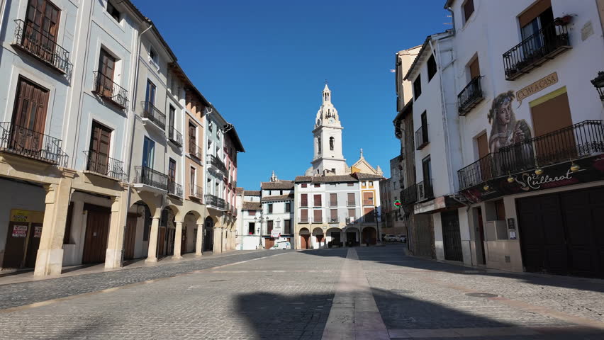 One of the main squares in Xativa Spain. A clocktower and historic buildings are seen all around in this quiet and peaceful town