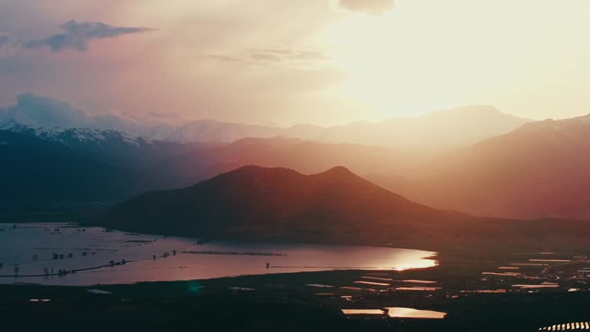 Peaceful Reflection of Mountains in a Calm Lake During Sunset
