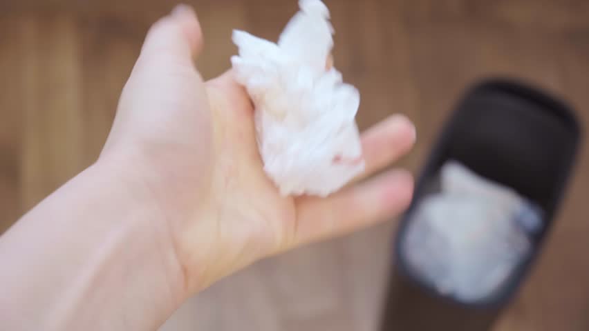Close up of hands crumpling paper and throwing it in trash daily office tasks workspace organization and cleanup