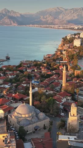 Aerial view of Antalya old town Kaleici and harbor, vertical drone panorama of Turkish coast. Mosque and clock tower in Antalya old city, Turkey