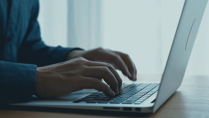 Close-Up of Hands Typing on Laptop with Digital Clock Overlay Representing Time Management and Productivity in a Modern Workspace Setting. Qubit.