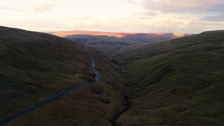 Scenic aerial view of winding road in Yorkshire Dales at sunset