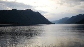 Early morning landscape of Teletskoye lake in Altai Russia. Calm water, soft light and serene mountain atmosphere near Artybash. High quality 4k footage - Powered by Shutterstock - Get 15% off with code: PIKWIZARD15