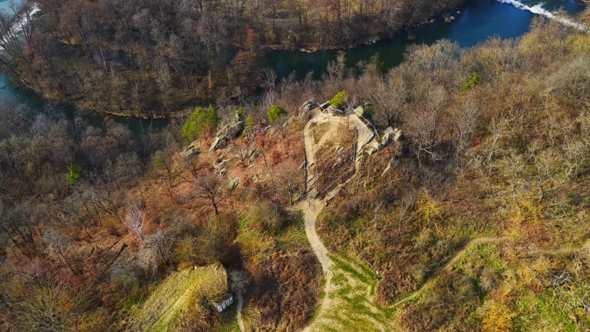 Aerial drone view of the Dyje (Thaya) River winding through forested canyon in Podyjí National Park, Czech Republic. Scenic autumn landscape with cliffs, hiking trails and untouched nature.
