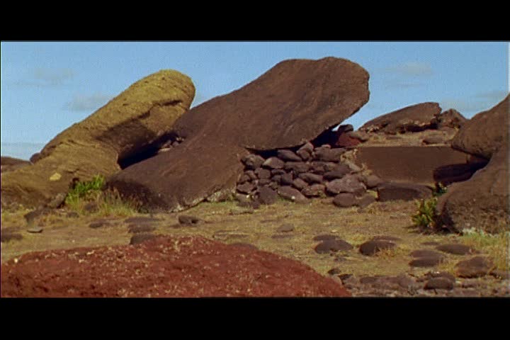 MS camera pans right across row of fallen moai statues on Easter Island, Chile.