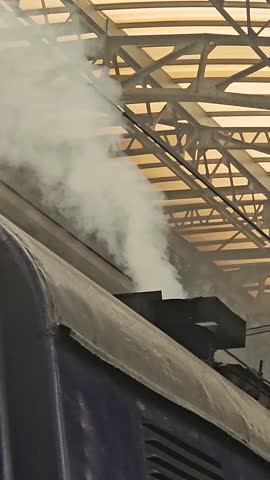 Train station smoke Steam and smoke coming from chimney of steam train tourist transport