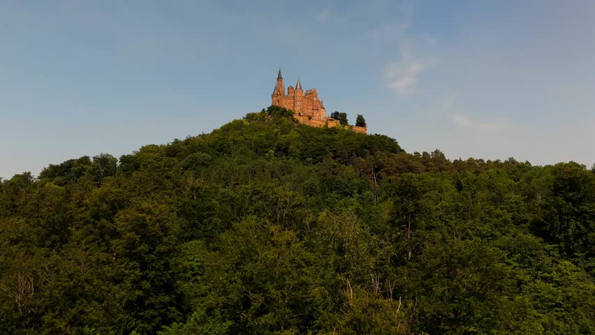 Aerial drone view of Hohenzollern Castle in Bisingen, Baden-Wuerttemberg, Germany. Famous hilltop fortress on the Swabian Alb with neogothic architecture, panoramic landscapes and cultural heritage. 
