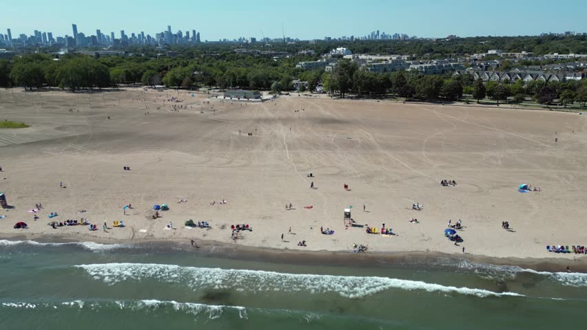 Cinematic Panorama of Toronto Urban Beach Life on Lake Ontario with Downtown Skyline in the Distance