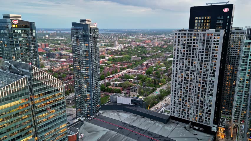 Montreal, Quebec, Canada - June  2024: Aerial view of downtown Montreal skyline at dusk with illuminated skyscrapers and urban buildings.