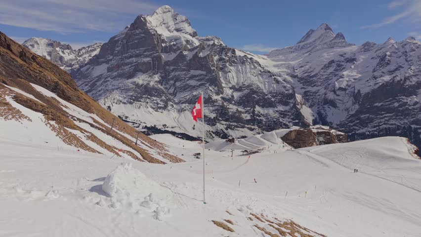 Aerial perspective of the Grindelwald First station building and mountain restaurant in winter.