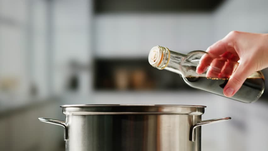 Asian Japanese soy sauce, Dark brown soy sauce pouring down into the glass bowl close up