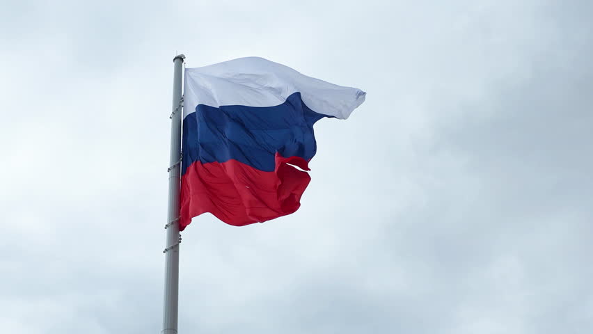 Russian federation flag waving in the wind against a cloudy sky symbolizing national pride and patriotism