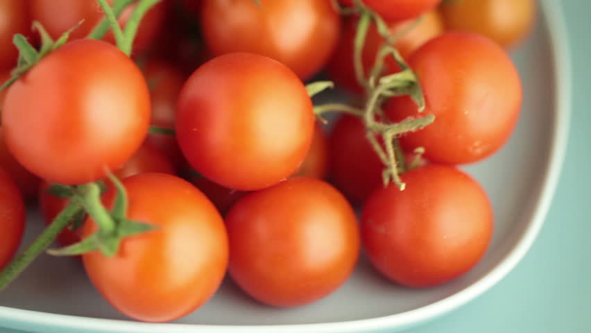 Red tomatoes in a plate rotate